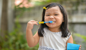 Young Girl Brushing Teeth