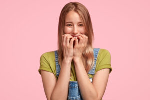 young adult biting her nails